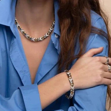 Photo of Braided Link Bracelet in a decorative scene, designed by , available at Plumb Gold & Plumb Silver