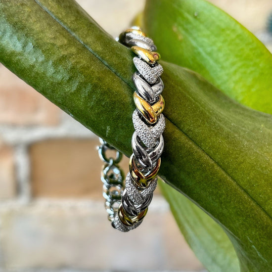 Photo of Braided Link Bracelet in a decorative scene, designed by , available at Plumb Gold & Plumb Silver