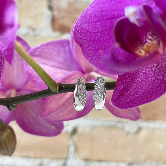 Photo of Breuning Diamond Leaf Earrings in a decorative scene, designed by , available at Plumb Gold & Plumb Silver