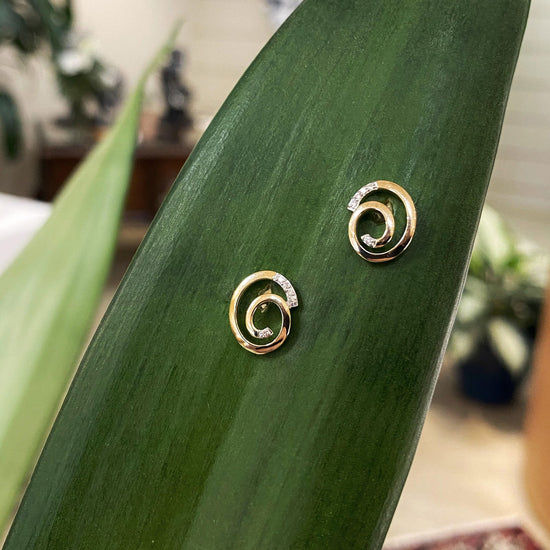 Photo of Breuning Sprial Studs in a decorative scene, designed by , available at Plumb Gold & Plumb Silver