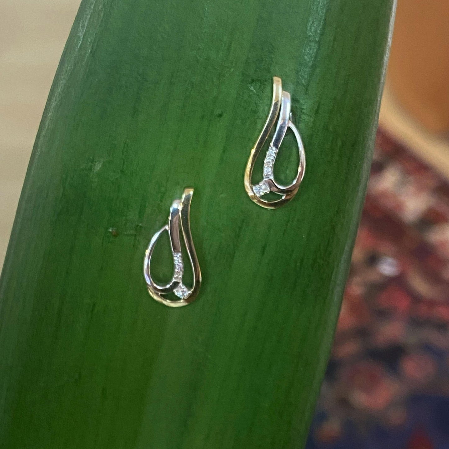Photo of Breuning Two-Tone Teardrop Earring in a decorative scene, designed by , available at Plumb Gold & Plumb Silver