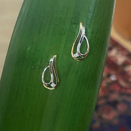 Photo of Breuning Two-Tone Teardrop Earring in a decorative scene, designed by , available at Plumb Gold & Plumb Silver