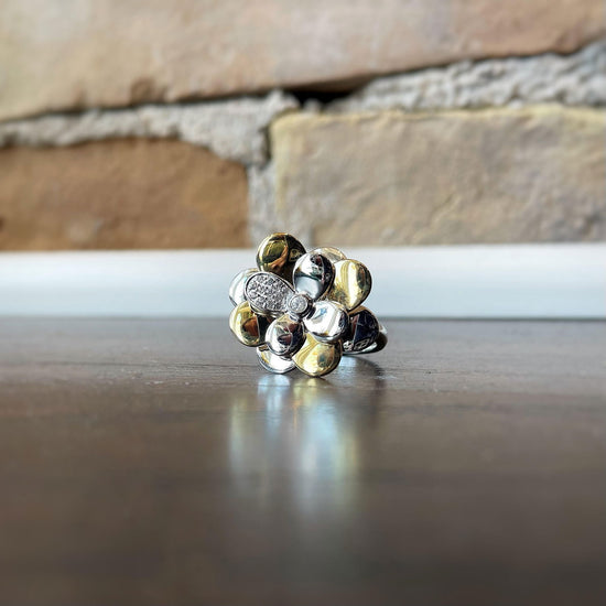 Photo of Breuning White Sapphire Flower Ring in a decorative scene, designed by , available at Plumb Gold & Plumb Silver