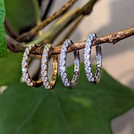 Photo of CZ Hinged Hoop Earring in a decorative scene, designed by , available at Plumb Gold & Plumb Silver