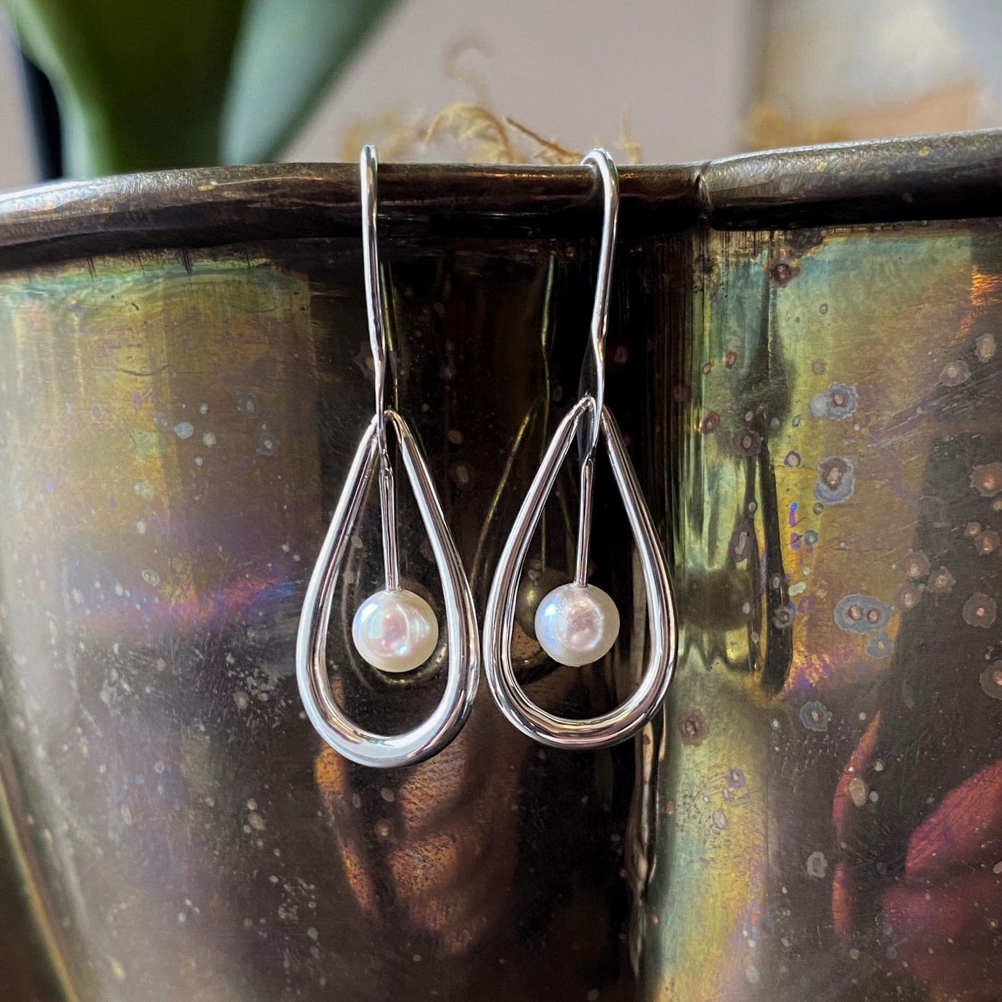 Photo of "Cachet" Earrings in a decorative scene, designed by , available at Plumb Gold & Plumb Silver