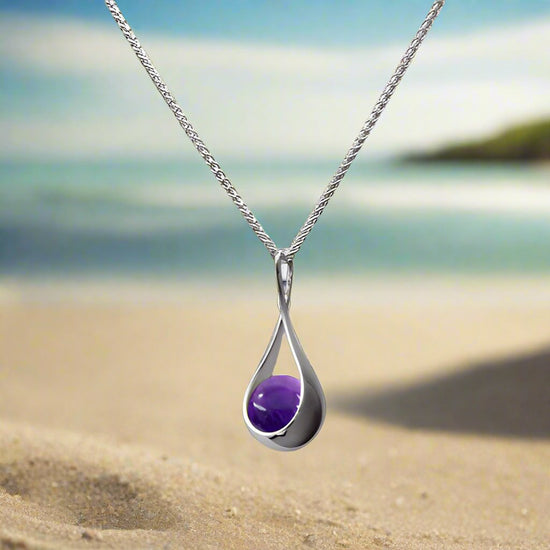 Photo of "Captivating" Amethyst Necklace in a decorative scene, designed by , available at Plumb Gold & Plumb Silver