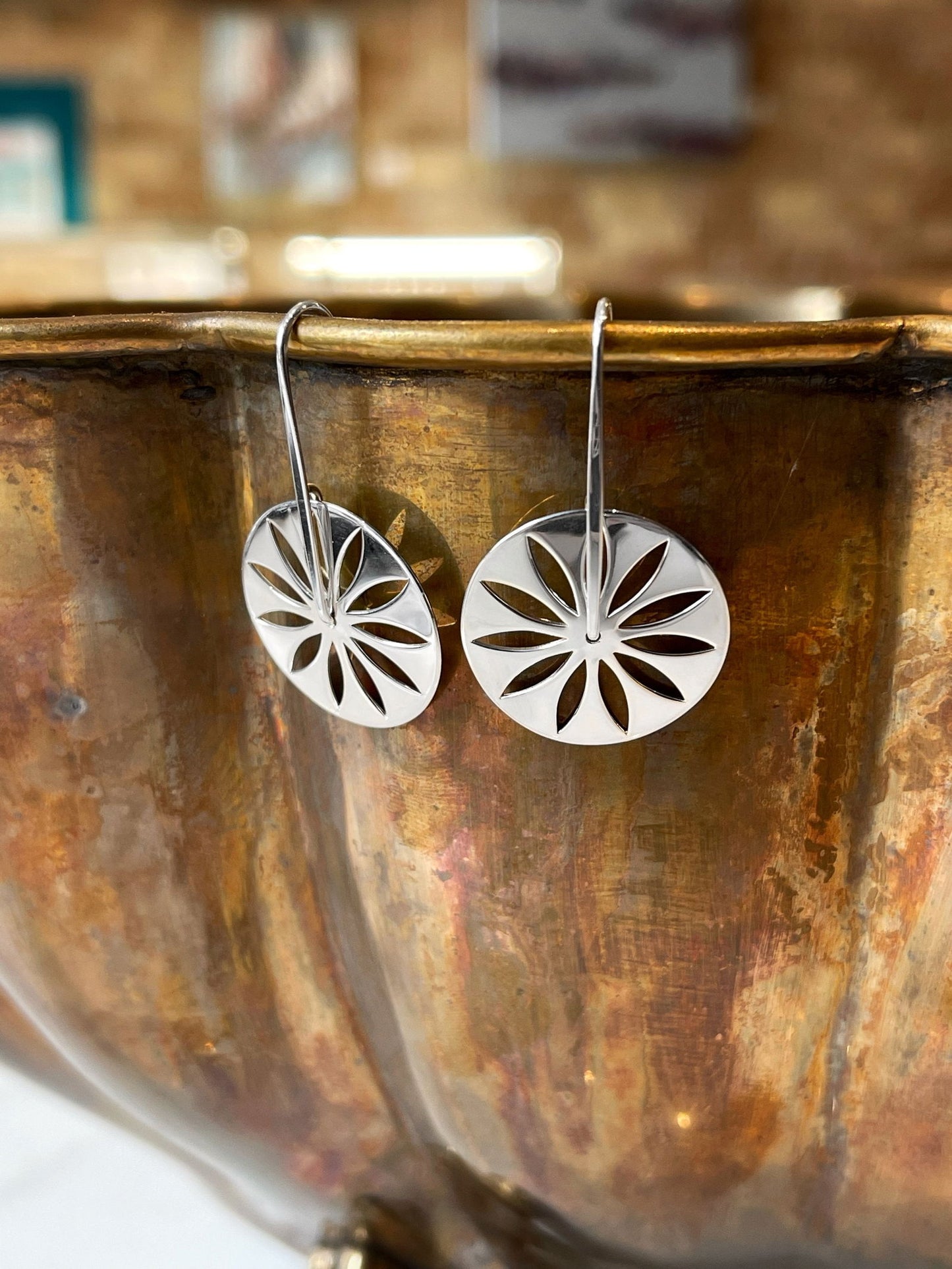 Photo of "Carnival" Earrings in a decorative scene, designed by , available at Plumb Gold & Plumb Silver