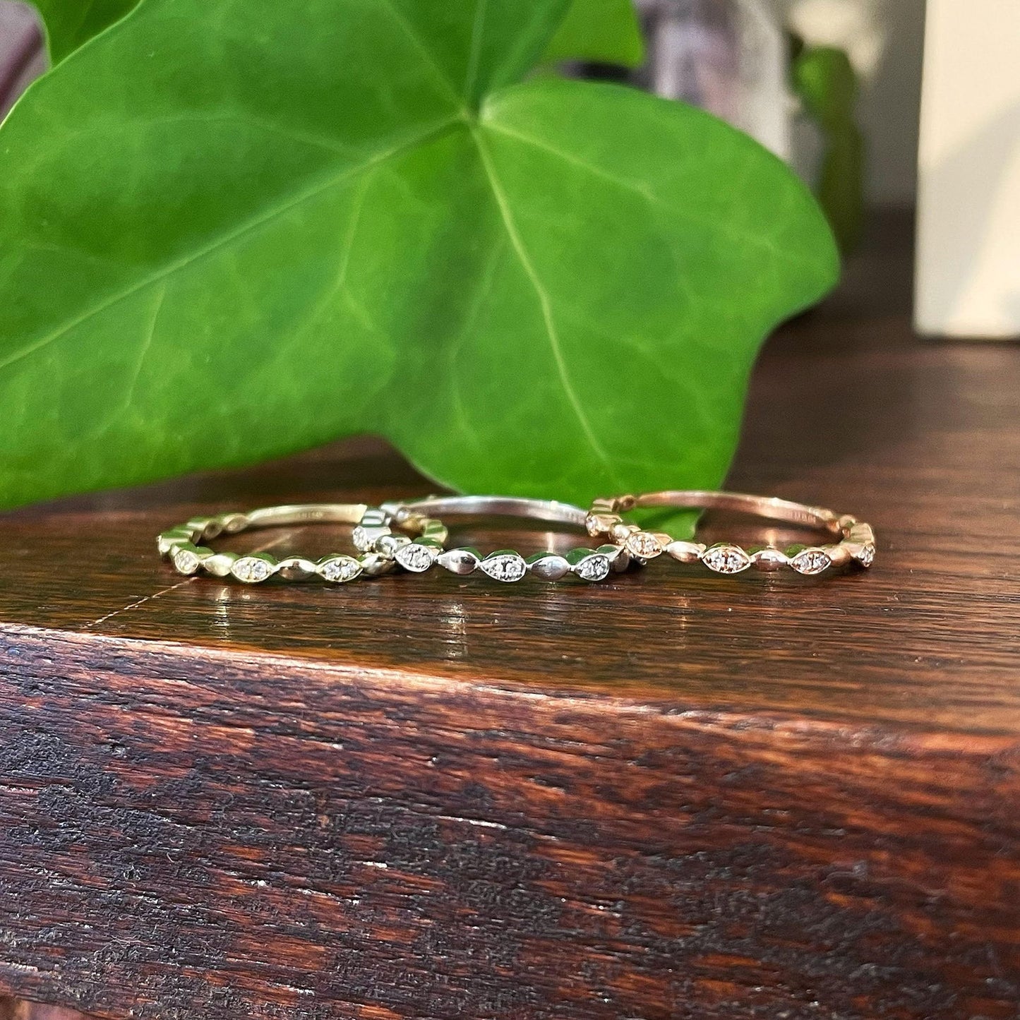 Photo of "Celeste" Marquise Band in a decorative scene, designed by , available at Plumb Gold & Plumb Silver