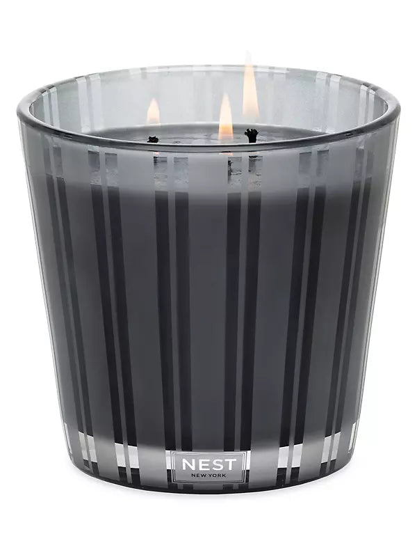 Photo of Charcoal Woods Candle in a decorative scene, designed by , available at Plumb Gold & Plumb Silver