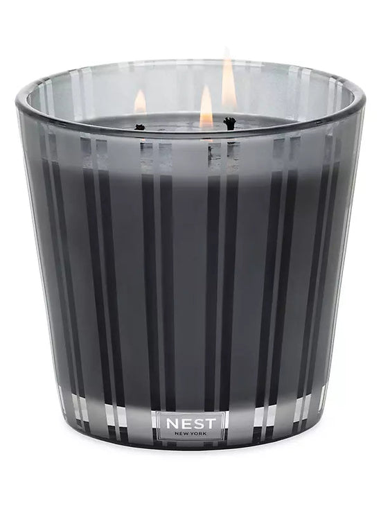 Photo of Charcoal Woods Candle in a decorative scene, designed by , available at Plumb Gold & Plumb Silver