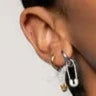 Photo of Chic pin charm in a decorative scene, designed by , available at Plumb Gold & Plumb Silver