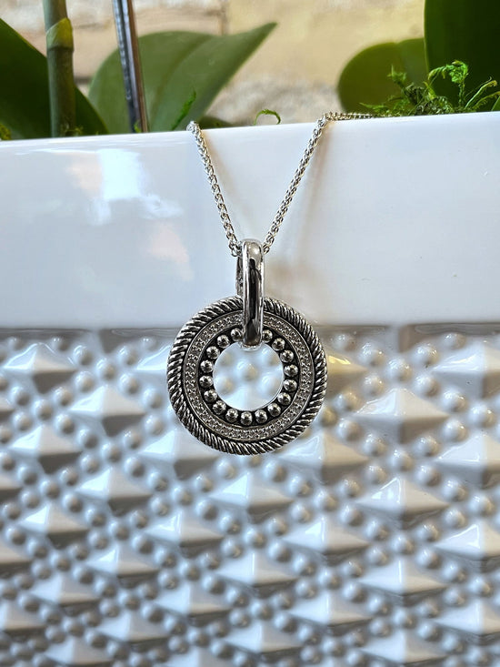 Photo of Circle Pendant in a decorative scene, designed by , available at Plumb Gold & Plumb Silver