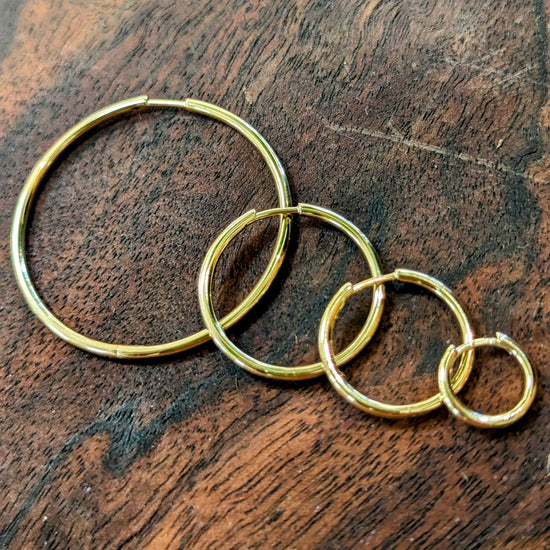 Photo of Classic Hinged Hoop in a decorative scene, designed by , available at Plumb Gold & Plumb Silver