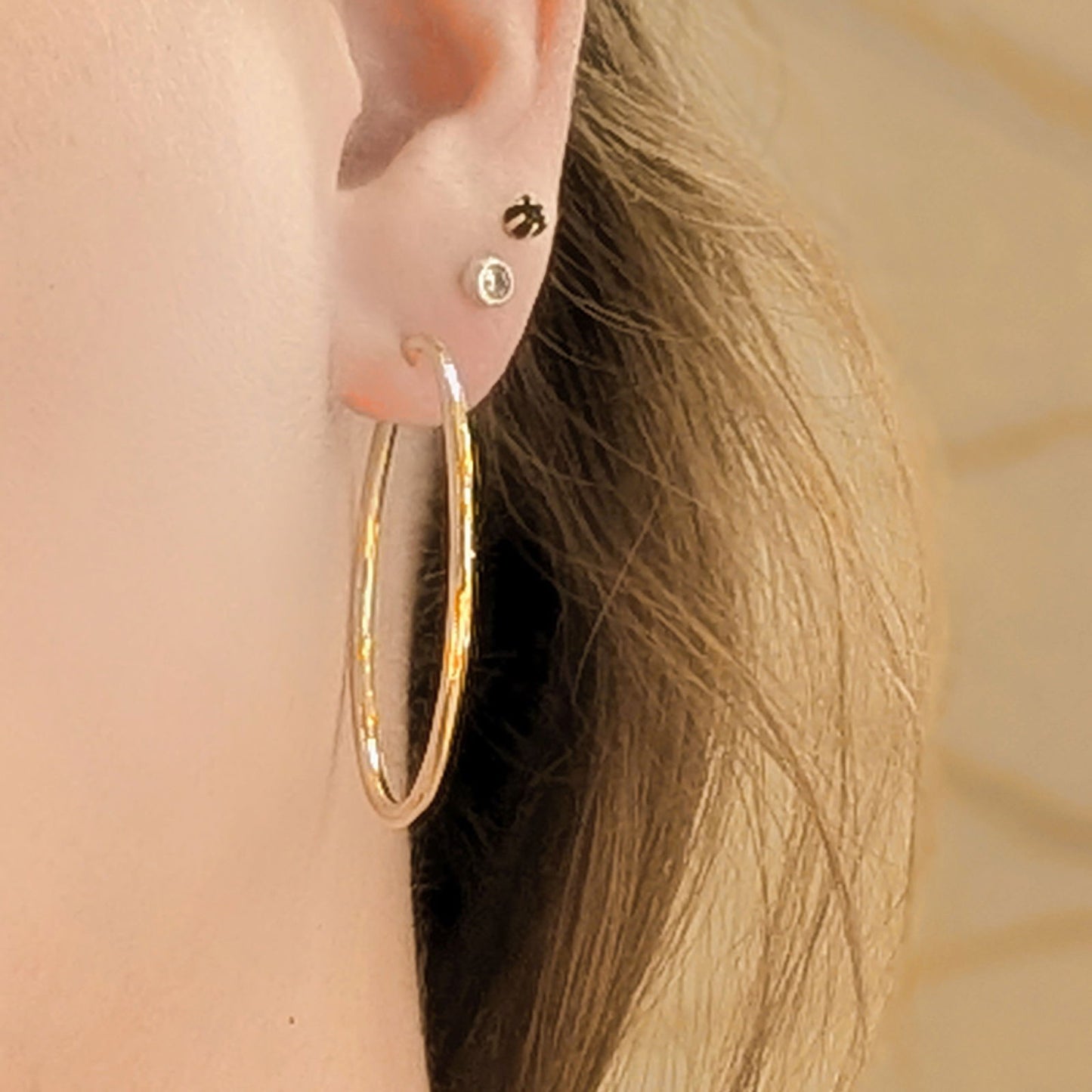 Photo of Classic Hinged Hoop in a decorative scene, designed by , available at Plumb Gold & Plumb Silver