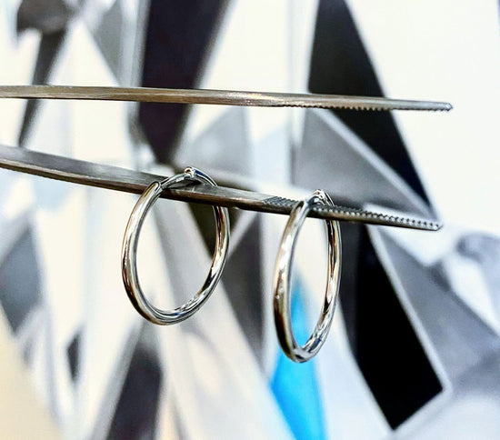 Photo of Classic Hinged Hoop in a decorative scene, designed by , available at Plumb Gold & Plumb Silver