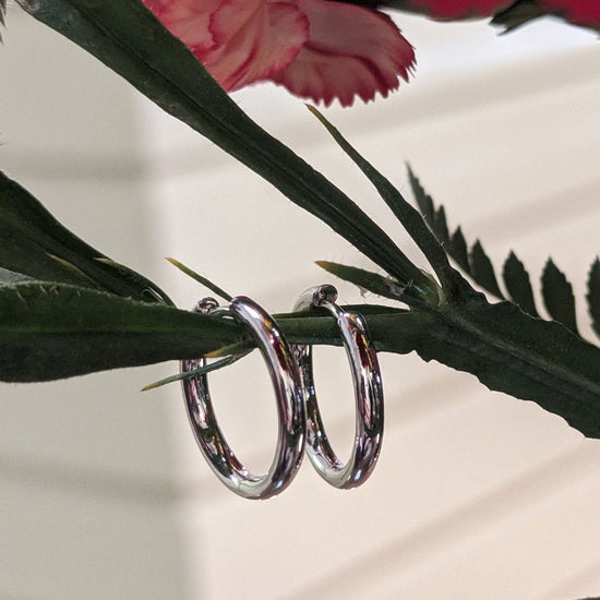Photo of Classic Hinged Hoops in a decorative scene, designed by , available at Plumb Gold & Plumb Silver