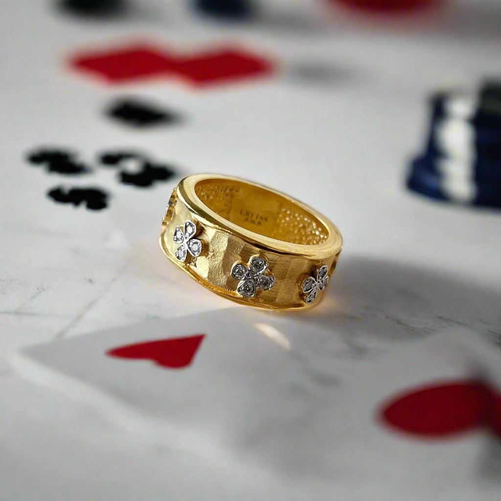 Photo of "Clover" Ring in a decorative scene, designed by , available at Plumb Gold & Plumb Silver