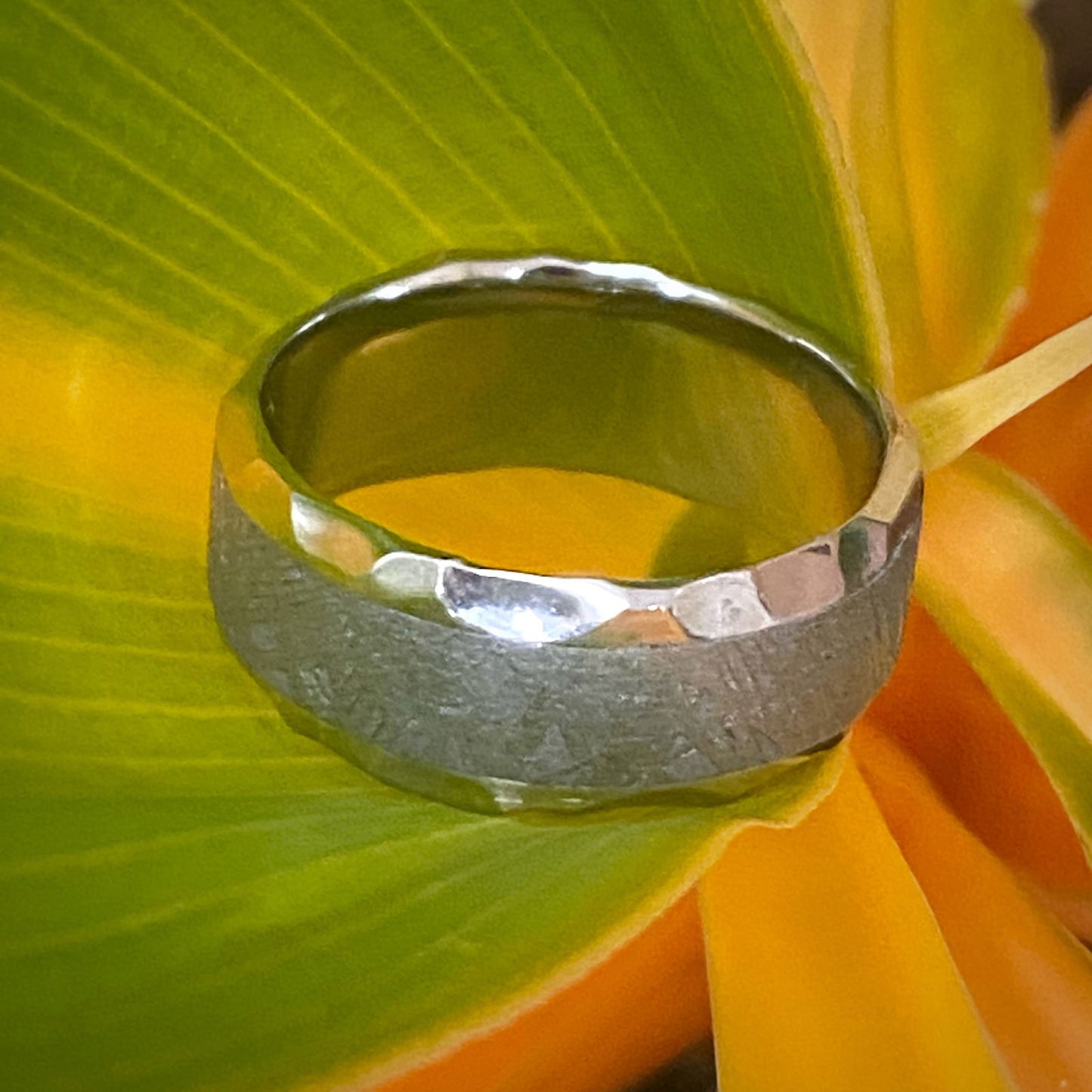 Photo of Cobalt Chrome Rock Finish Beveled Edge Band in a decorative scene, designed by -, available at Plumb Gold & Plumb Silver