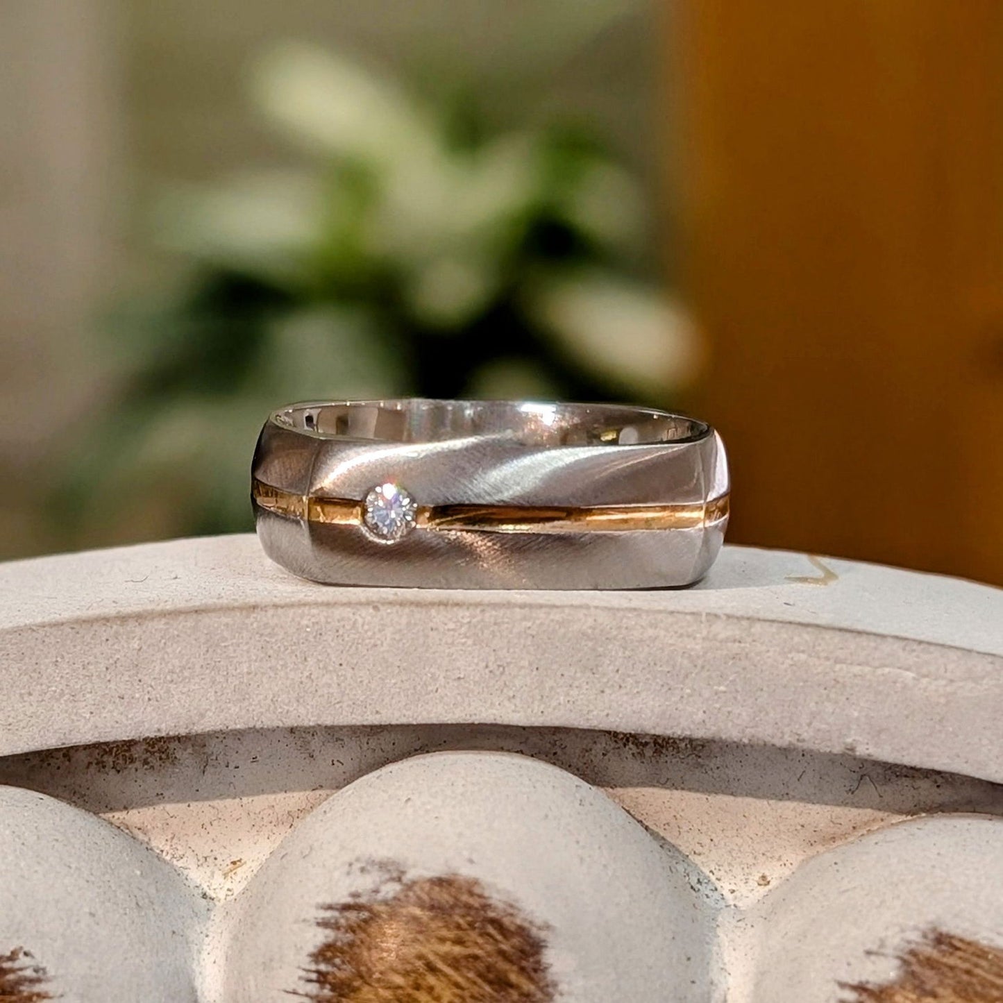 Photo of Cobalt Chrome Squared Band in a decorative scene, designed by -, available at Plumb Gold & Plumb Silver
