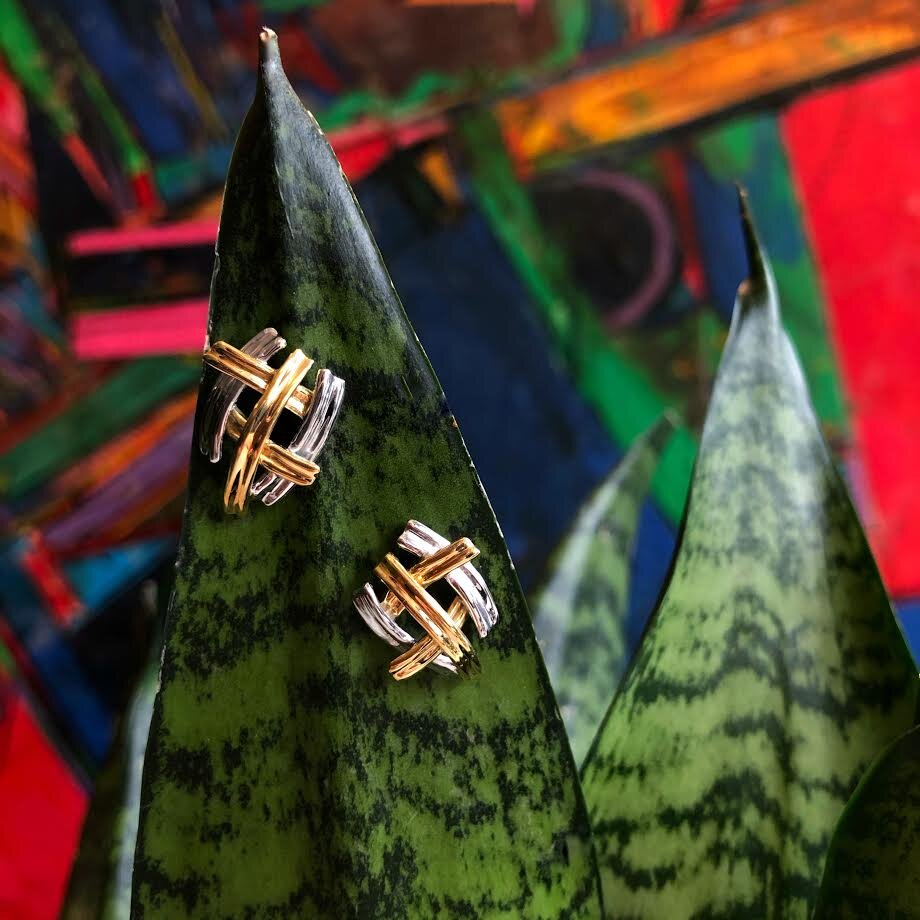 Photo of Criss-Cross Stud Earrings in a decorative scene, designed by , available at Plumb Gold & Plumb Silver