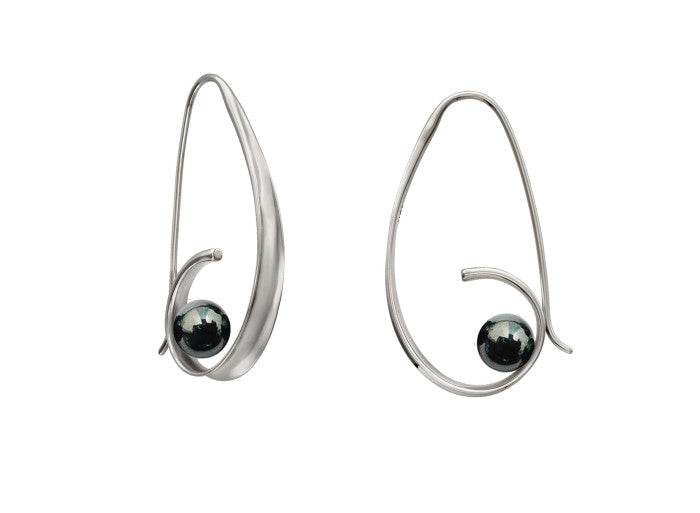Photo of "Crosswind" Earrings in a decorative scene, designed by , available at Plumb Gold & Plumb Silver
