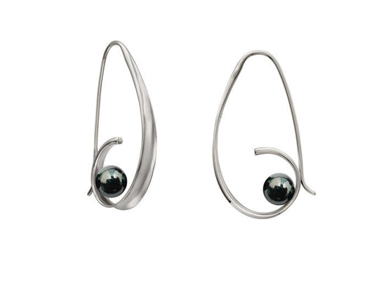 Photo of "Crosswind" Earrings in a decorative scene, designed by , available at Plumb Gold & Plumb Silver