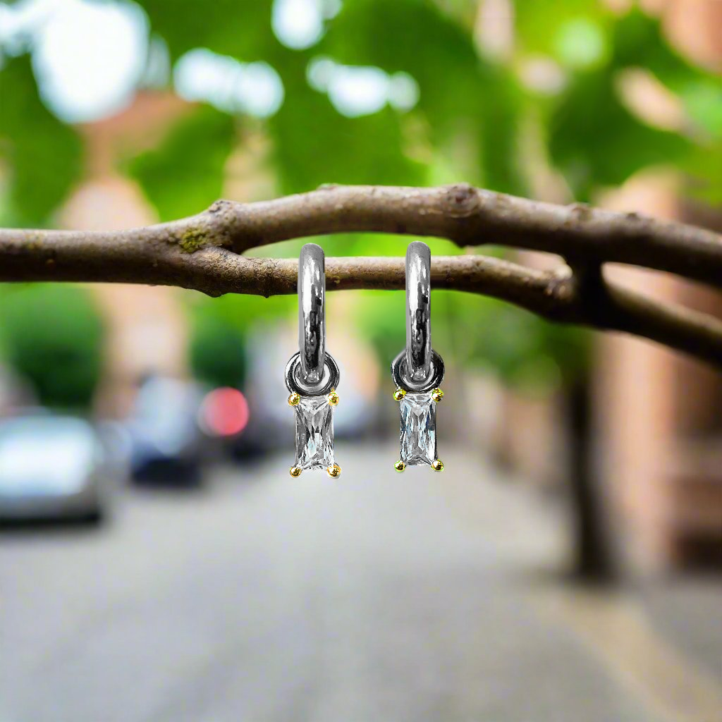 Photo of Cubic Zirconia Baguette Dangle Earrings in a decorative scene, designed by , available at Plumb Gold & Plumb Silver