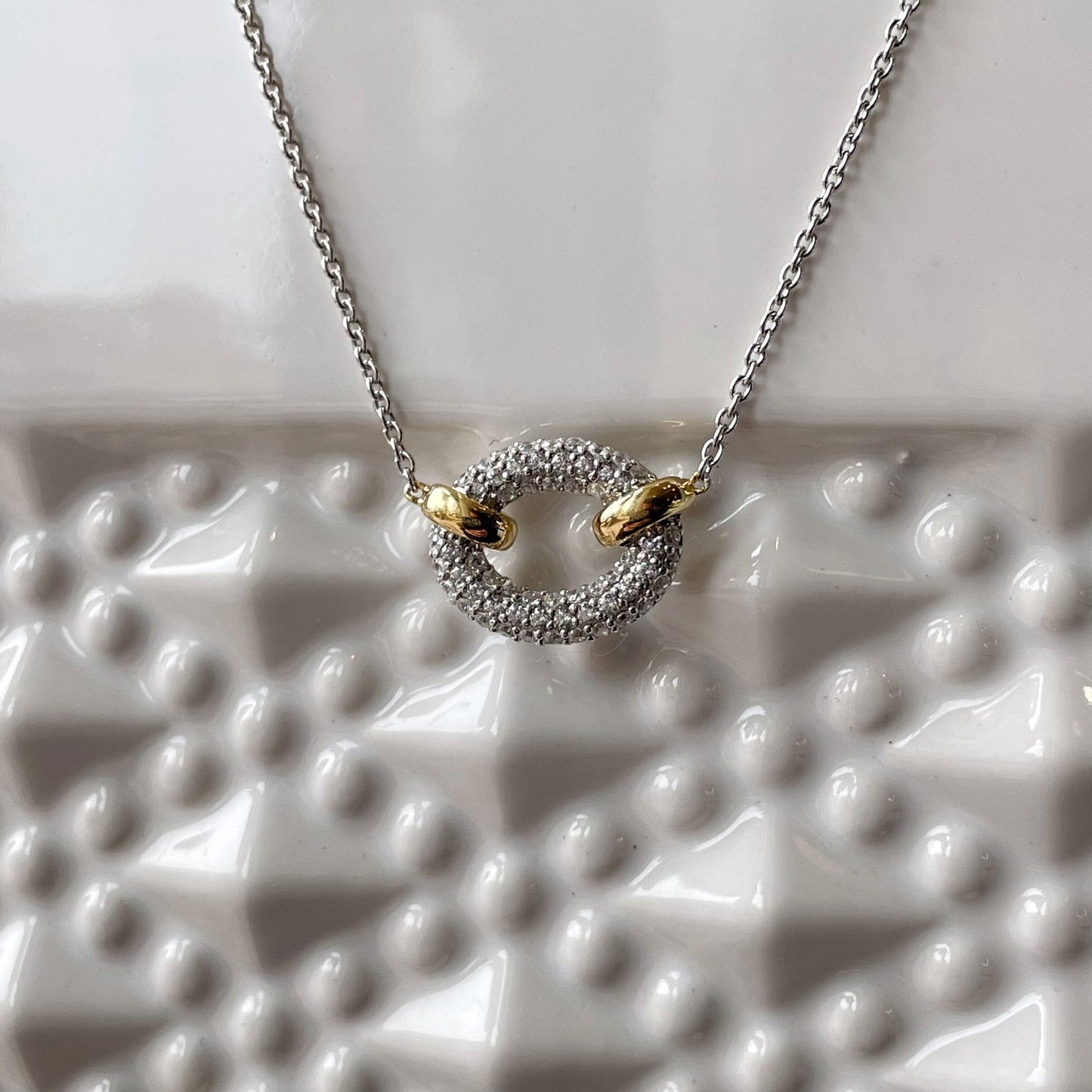 Photo of Cubic Zirconia Oval Necklace in a decorative scene, designed by , available at Plumb Gold & Plumb Silver