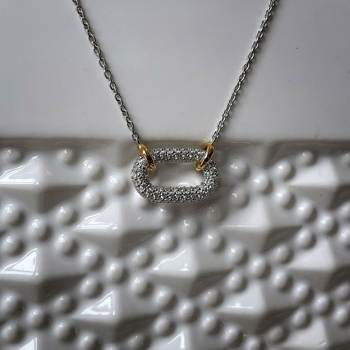 Photo of Cubic Zirconia Oval Necklace in a decorative scene, designed by , available at Plumb Gold & Plumb Silver