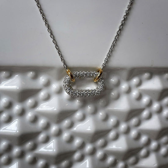Photo of Cubic Zirconia Oval Necklace in a decorative scene, designed by , available at Plumb Gold & Plumb Silver