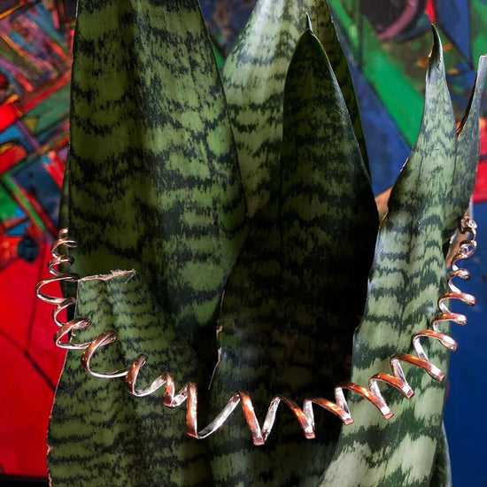 Photo of "Curls" Collar in a decorative scene, designed by , available at Plumb Gold & Plumb Silver