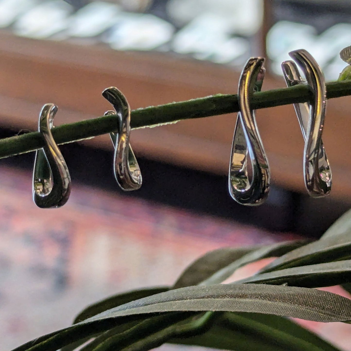 Photo of Curved Huggies in a decorative scene, designed by , available at Plumb Gold & Plumb Silver