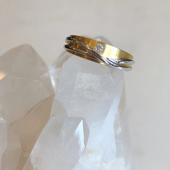 Photo of Curvy Line Ring in a decorative scene, designed by , available at Plumb Gold & Plumb Silver