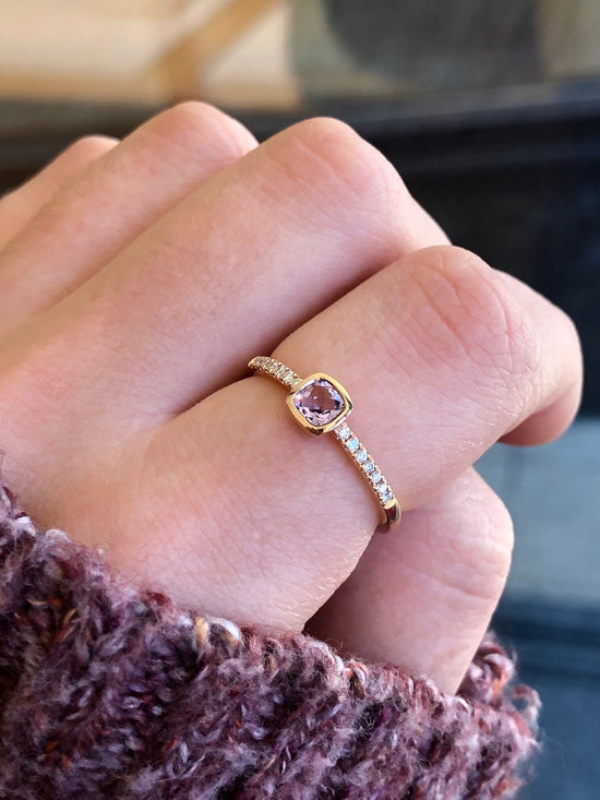 Photo of Cushion Rose de France Amethyst Ring in a decorative scene, designed by , available at Plumb Gold & Plumb Silver