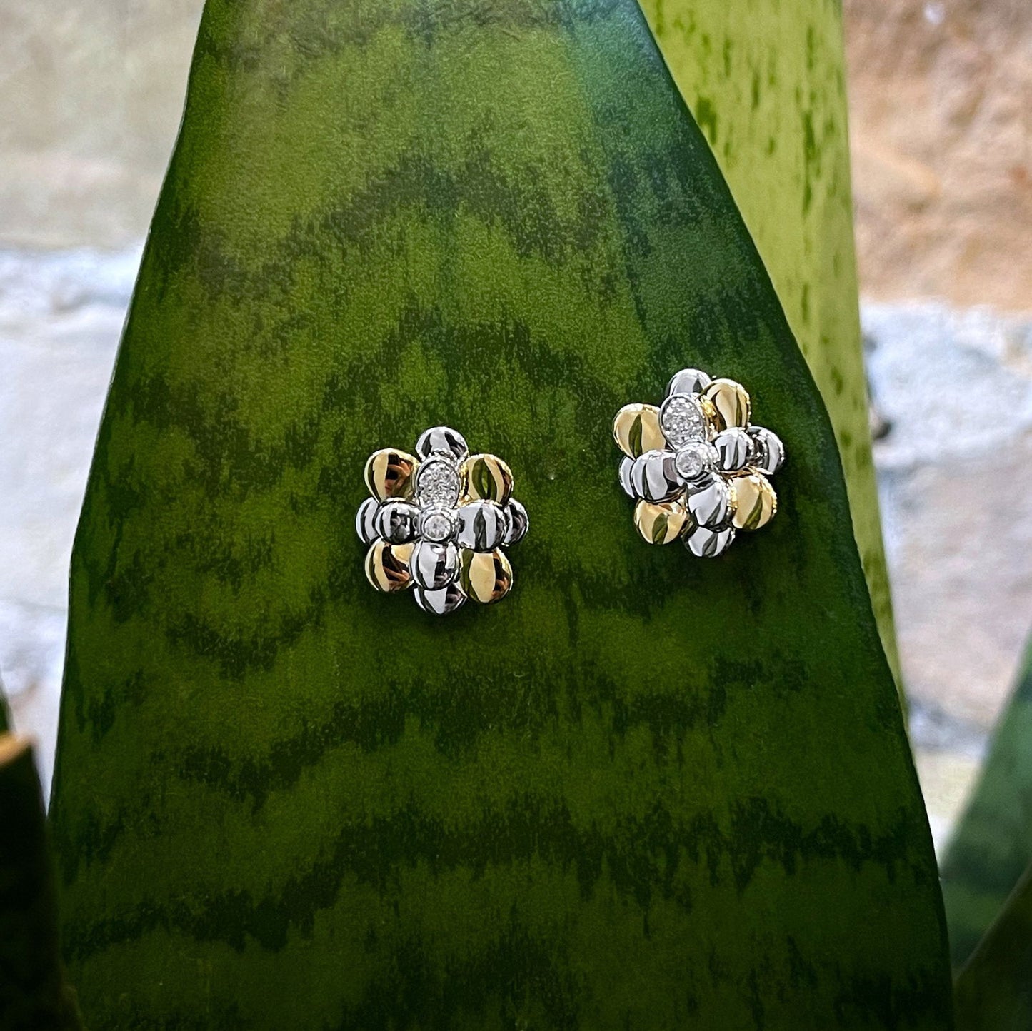 Photo of Daisy Studs in a decorative scene, designed by , available at Plumb Gold & Plumb Silver