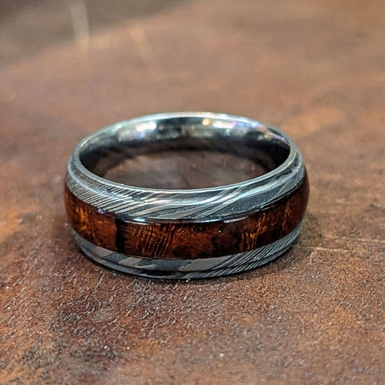 Photo of Damascus and Hardwood Band in a decorative scene, designed by , available at Plumb Gold & Plumb Silver