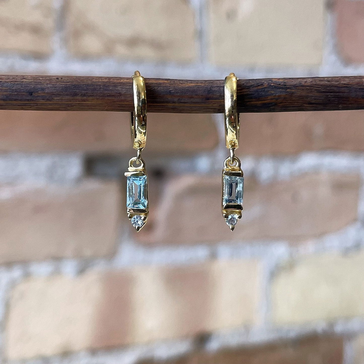 Photo of “Deco” Blue Topaz Dangles in a decorative scene, designed by , available at Plumb Gold & Plumb Silver