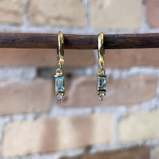 Photo of “Deco” Blue Topaz Dangles in a decorative scene, designed by , available at Plumb Gold & Plumb Silver