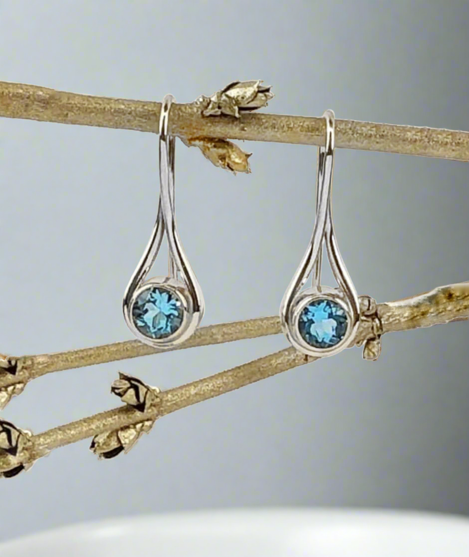 Photo of "Desire" Earrings in a decorative scene, designed by , available at Plumb Gold & Plumb Silver