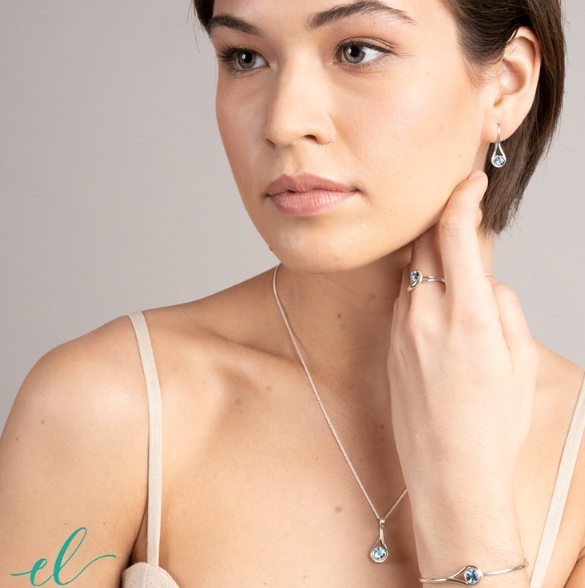 Photo of "Desire" Earrings in a decorative scene, designed by , available at Plumb Gold & Plumb Silver