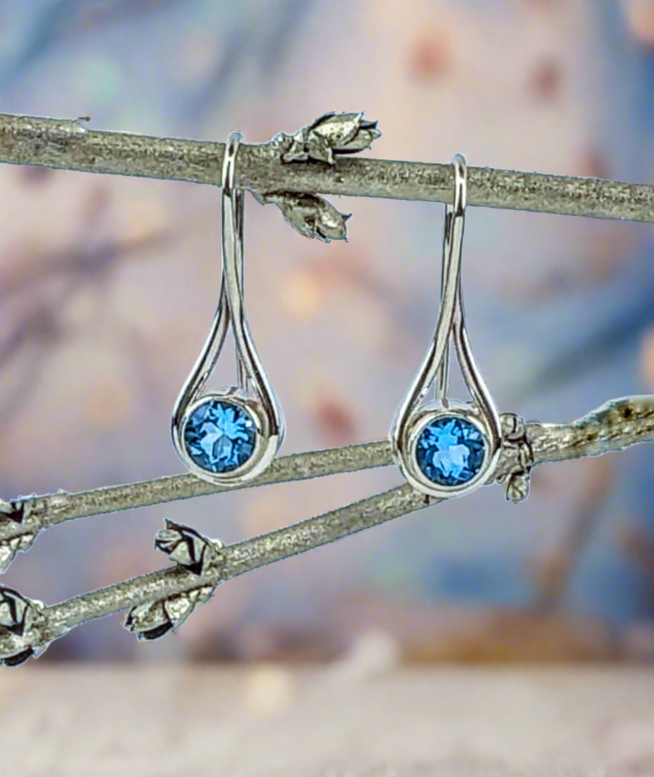 Photo of "Desire" Earrings in a decorative scene, designed by , available at Plumb Gold & Plumb Silver