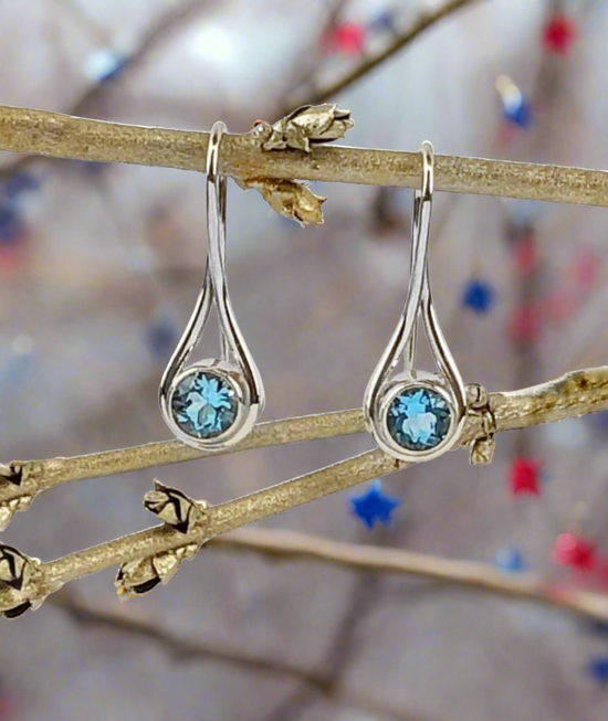 Photo of "Desire" Earrings in a decorative scene, designed by , available at Plumb Gold & Plumb Silver