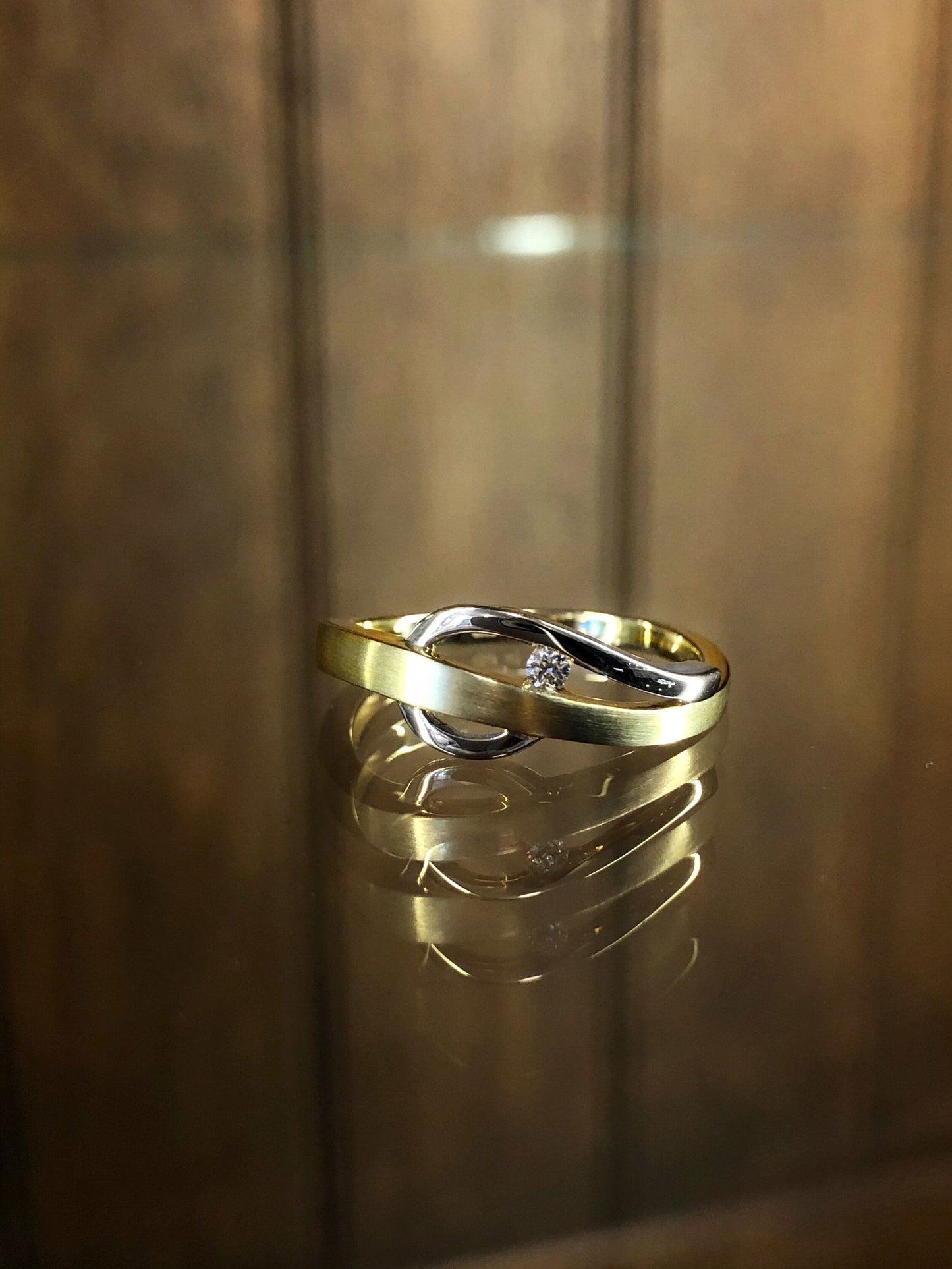 Photo of Diamond Cleft Ring in a decorative scene, designed by , available at Plumb Gold & Plumb Silver
