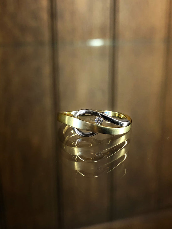 Photo of Diamond Cleft Ring in a decorative scene, designed by , available at Plumb Gold & Plumb Silver