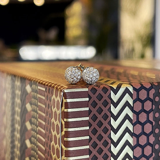 Photo of Diamond Cluster Studs in a decorative scene, designed by , available at Plumb Gold & Plumb Silver