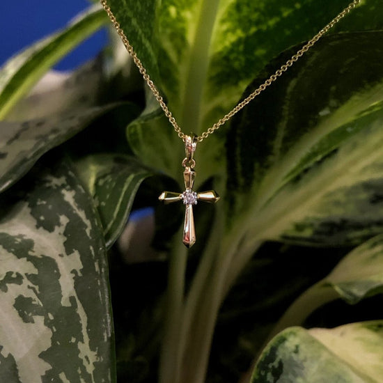 Photo of Diamond Cross Necklace in a decorative scene, designed by , available at Plumb Gold & Plumb Silver