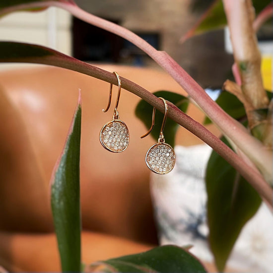 Photo of Diamond Disk Dangles in a decorative scene, designed by , available at Plumb Gold & Plumb Silver
