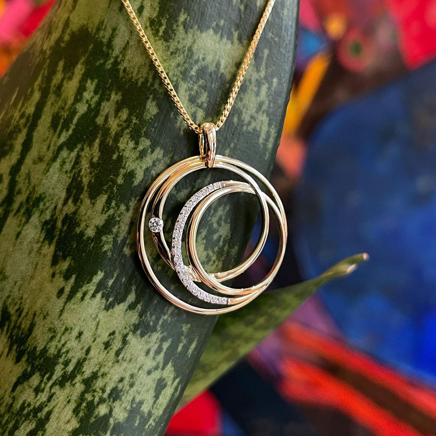 Photo of Diamond Entwine Pendant in a decorative scene, designed by , available at Plumb Gold & Plumb Silver