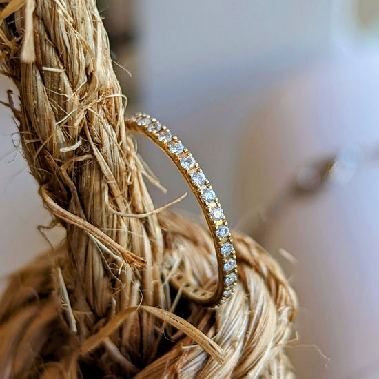Photo of Diamond Eternity Band in a decorative scene, designed by , available at Plumb Gold & Plumb Silver