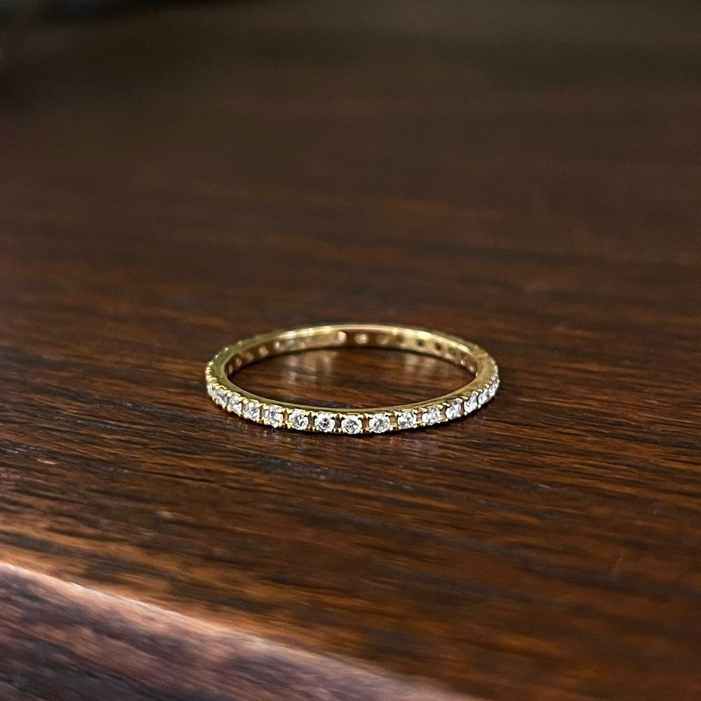 Photo of Diamond Eternity Band in a decorative scene, designed by , available at Plumb Gold & Plumb Silver